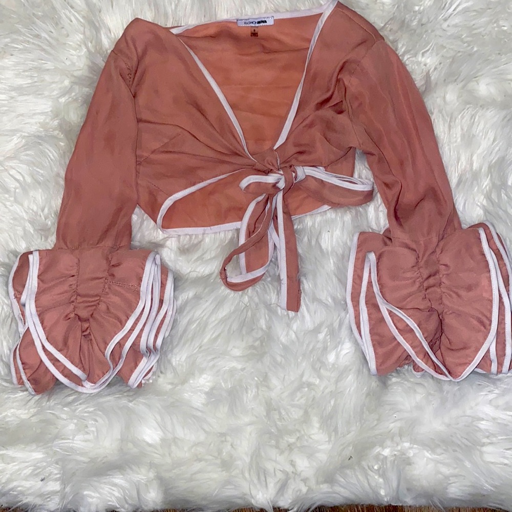 Fashion Nova crop top. It ties in the front and has wide sleeves.